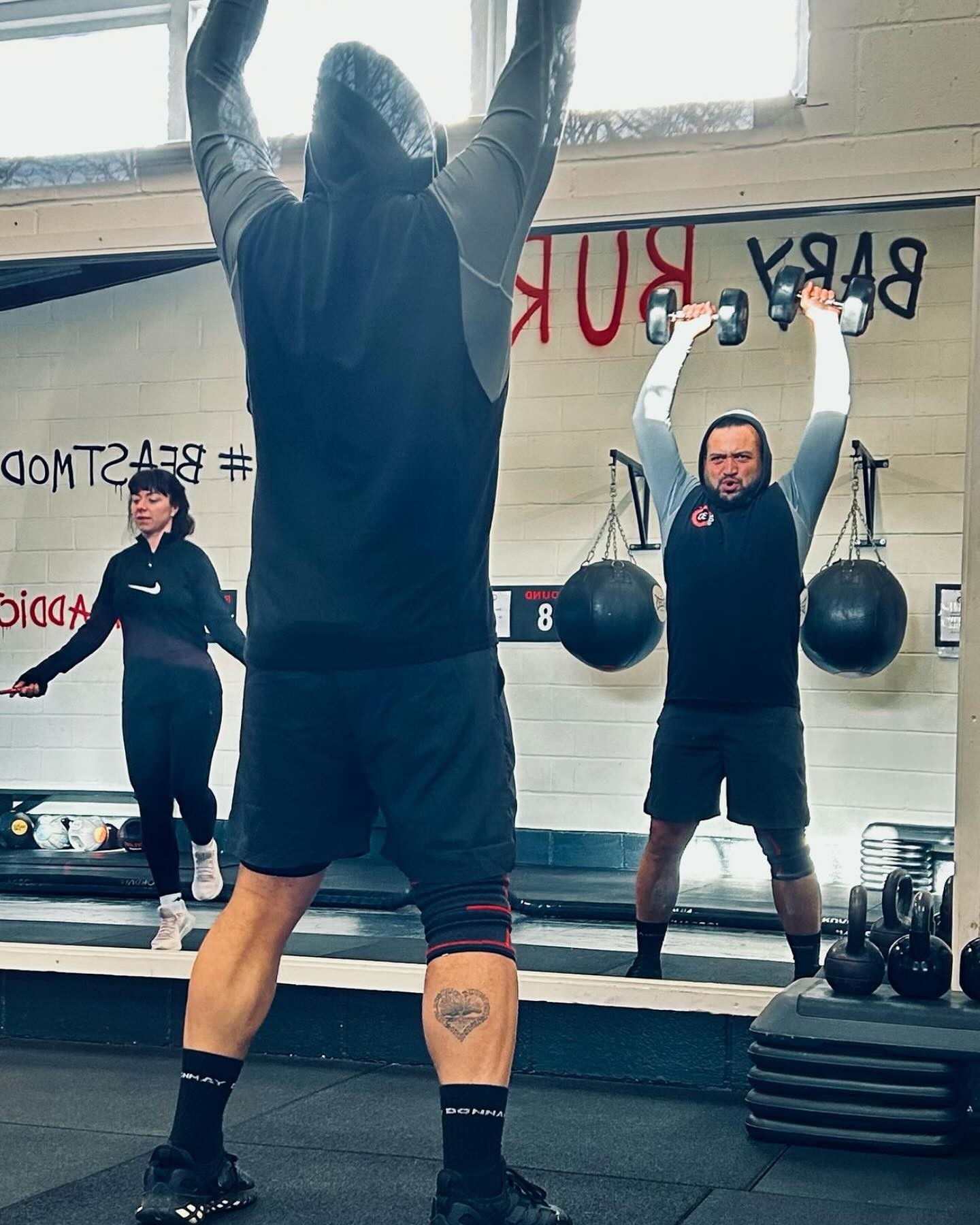 BOX30 member lifting weights during a circuit